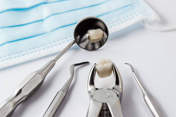 Surgical mask and dental tools with extracted tooth