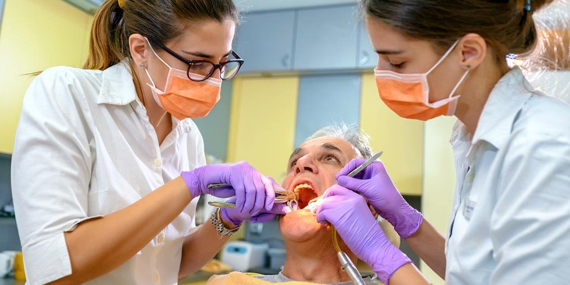 Dentist extracting a tooth from a patient.